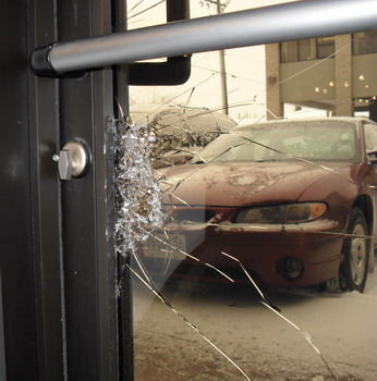 Photo of a business door with broken glass