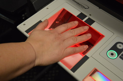 Image of a hand on the fingerprint scanning machine