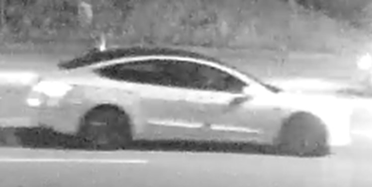 Surveillance camera image of white Tesla