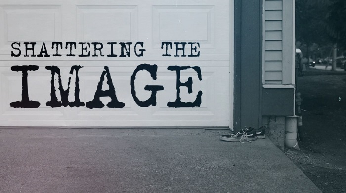 A still image from the Shattering the Image presentation video, featuring the words "Shattering the Image" on a white garage door, with a pair of sneakers on the driveway nearby.
