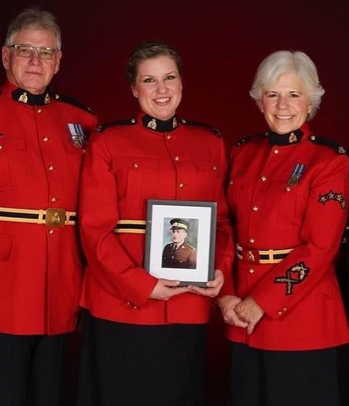 Constable Sandra Morse with her parents, Ron and Donna Morse. Sandra is holding a photo of her grandfather, Robert Burns.