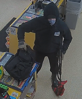 Photo of the suspect, seen wearing a black hoody with a photograph of the McLovin’ ID on the front, black pants and a black face covering.