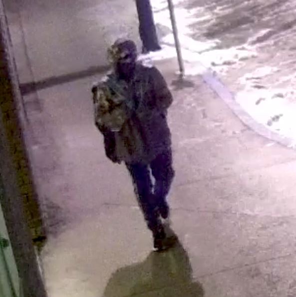 Suspect wearing Camo jacket, ski mask and black pants