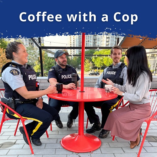 Police officers sitting outside around a table while drinking coffee and talking to the public