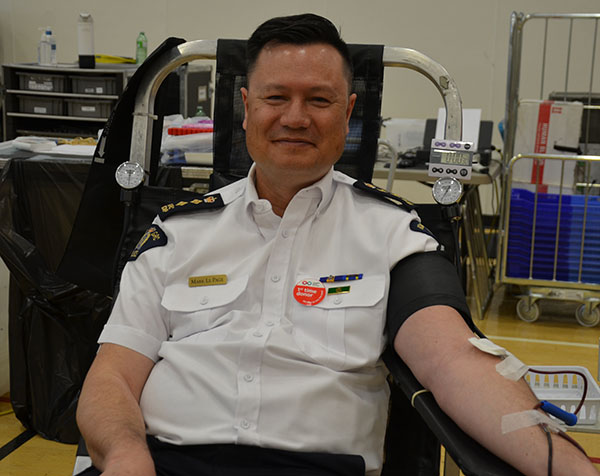 Photo of C/Supt. Mark LePage, Human Resources Officer, donating blood