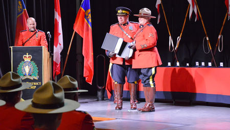 Photo of Corporal Madonna Saunderson receiving her award and certificate.