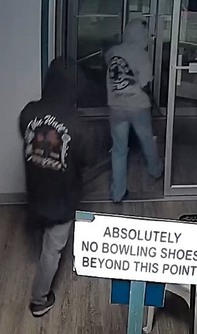 Two suspects exiting through the glass door