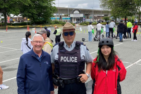 Richmond RCMP officer standing with City Councillor and volunteer