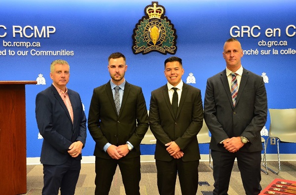 The four recently sworn in RCMP officers in a line.