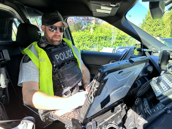 RCMP officer sitting inside a police car