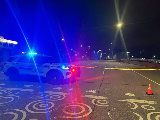 A police car with sirens on is pictured on North Vancouver's Low Road on June 22, 2024.