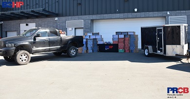 A black pickup truck, a cargo trailer, and 46 cases of illegal cigarettes