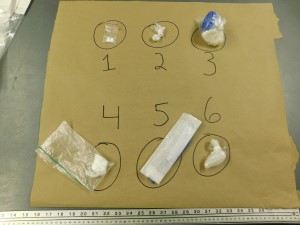 Various illicit drugs on a cardboard panel