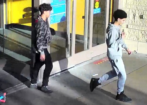 A side-profile of suspect one and suspect three leaving the store after the incident