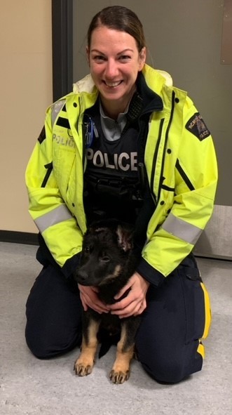 Constable Savoie with RCMP puppy Raddix