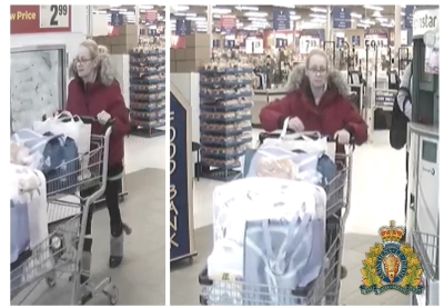 woman with blonde hair wearing glasses, wearing red coat with fur on the hood pushing a shopping cart