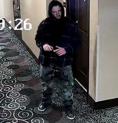 photo of male suspect wearing black hoodie and camo pants