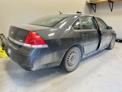 Photo de l’arrière et du côté passager du véhicule Chevrolet Impala gris foncé.
