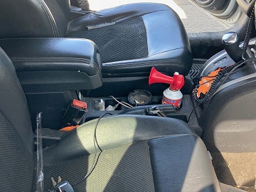Photo of centre console, pistol partially visible in front of air horn
