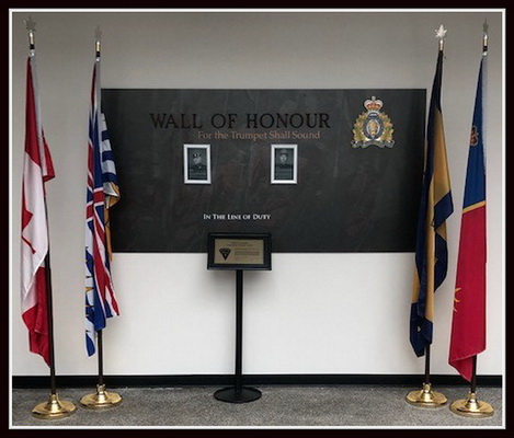 photo of Wall of Honour with photos of Richmond RCMP officers killed in the line of duty and flags