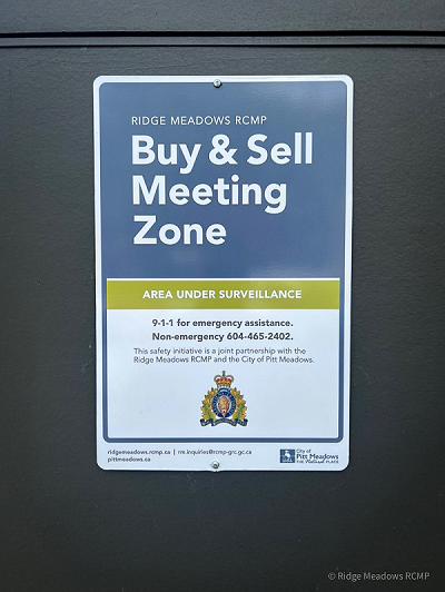 new "Buy and Sell Safe Zone" sign near the Pitt Meadows Community Policing Office reading "Buy & Sell Meeting Zone"
