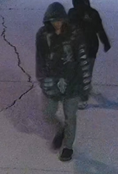 male youth suspect with a grey hoodie with writing down the left sleeve and light markings