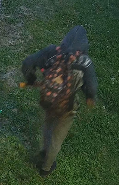 male youth suspect wearing a grey hoodie and a backpack with potentially orange and yellow markings