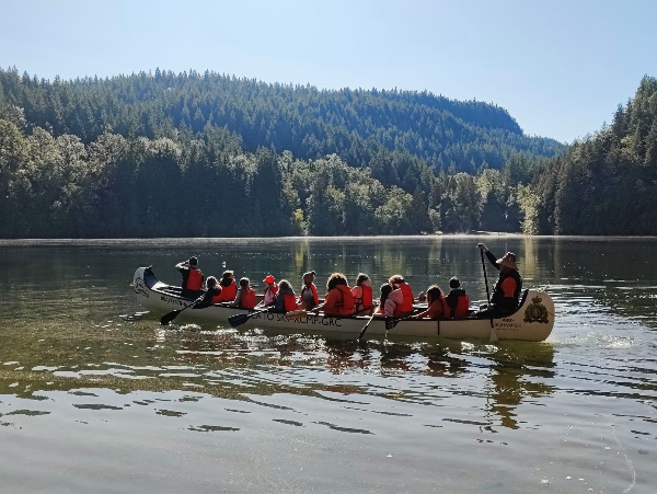 Squamish Nation and RCMP paddling in the Little Thunderbird Canoe on Alice Lake 