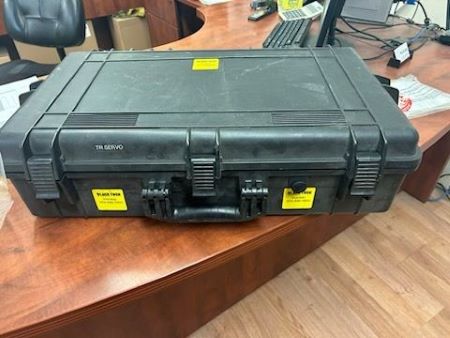 A black pelican case with yellow tabs. 