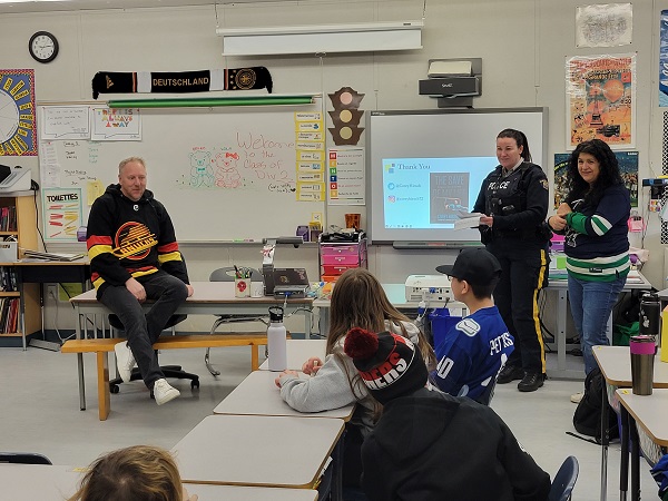 Photo: Left to right Corey Hirshe, Cst. Chantal Sears, and Mme. Yalpani talking to students