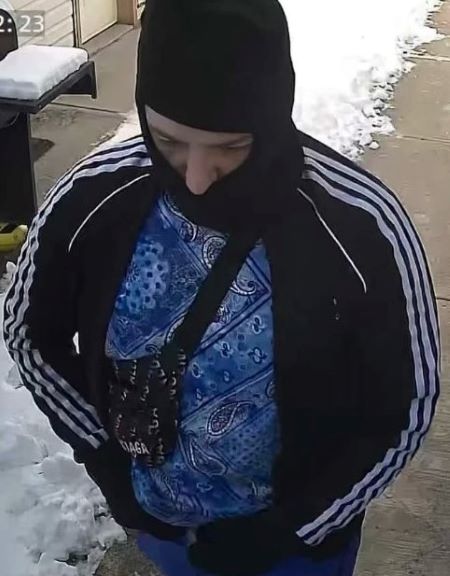 Suspect two - face covered, male, longer nose, wearing a blue track suit with three white stripes on its arms and legs, approximately 30 years old, 6’.